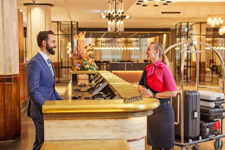 Joanne Johnsen from Qantas’ check in ground crew and Kimpton Margot Hotel team member, Mitch, get ready to check in more Qantas Hotels and Holidays customers.